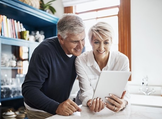 a couple with tab and discuss about best strategies for long-term stock investments