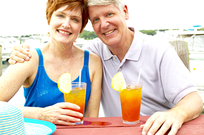 Mature man and woman with beverages