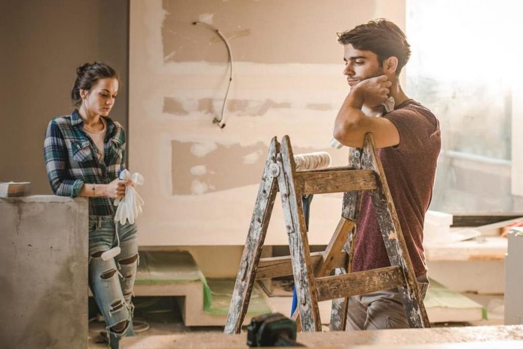 Young couple working on their house renovation